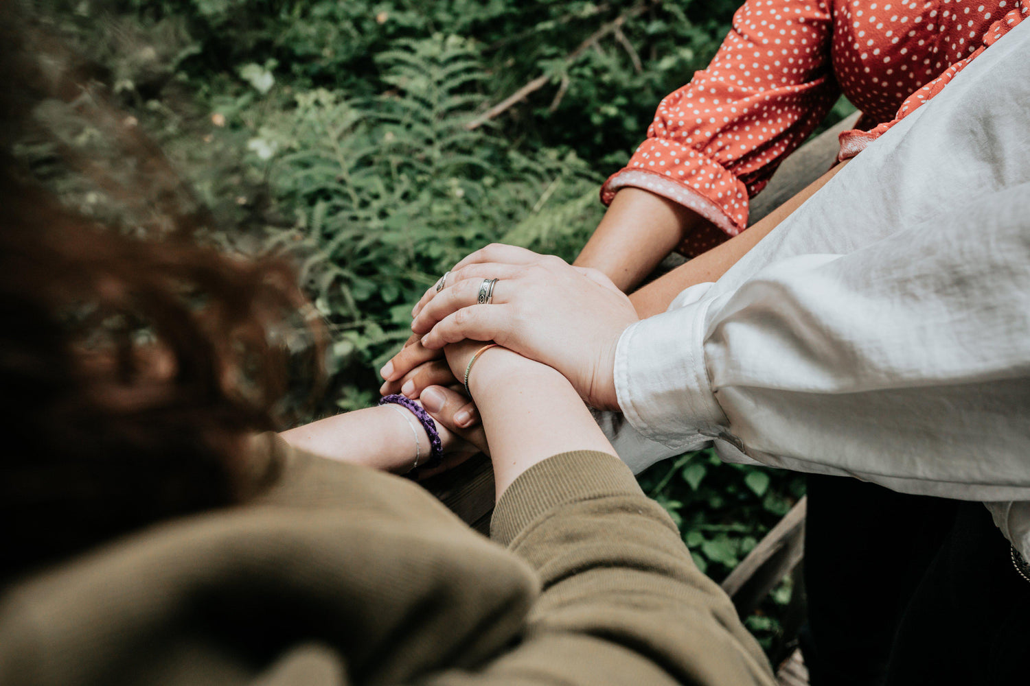 arms-reach-into-pile-hands-on-top-of-each-other